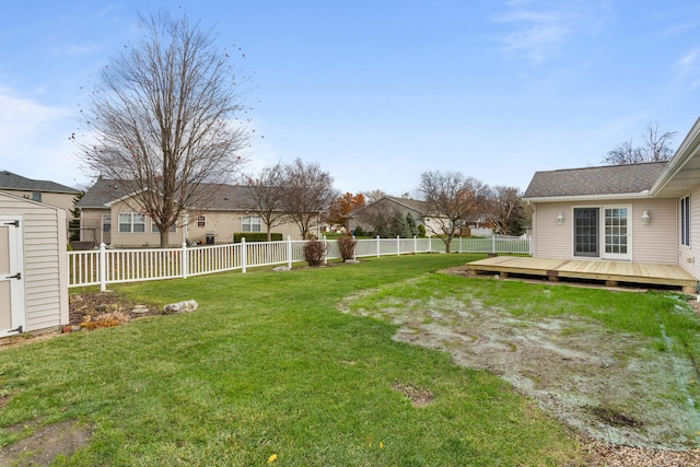 view of yard with a shed and a deck