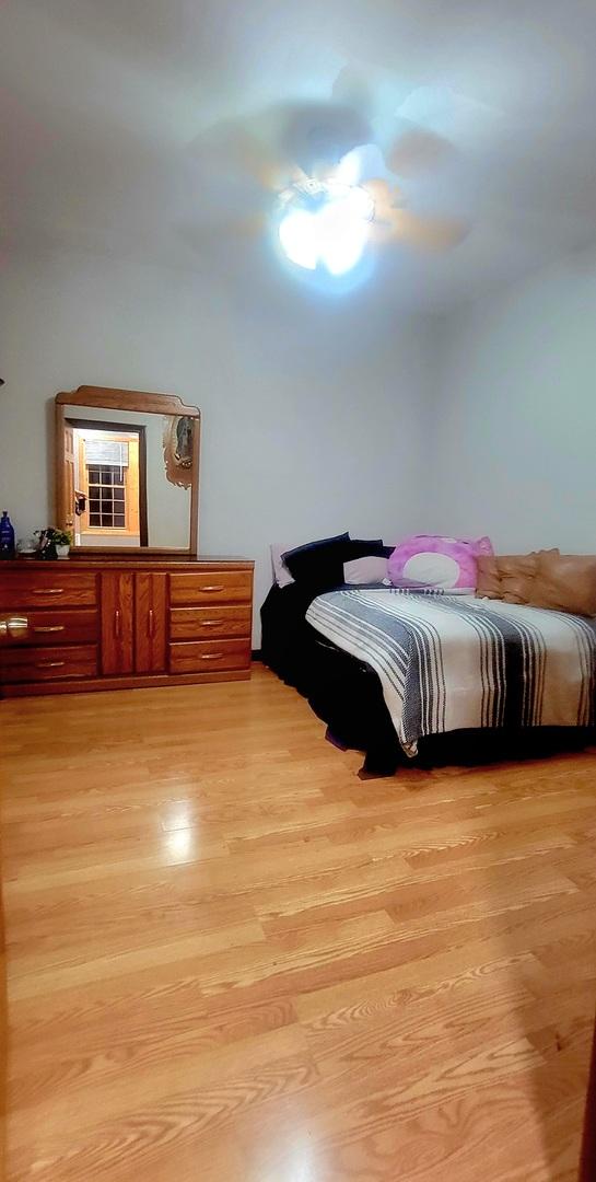 bedroom featuring ceiling fan and light wood-type flooring