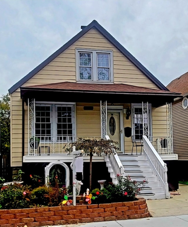 bungalow-style home with covered porch and stairway