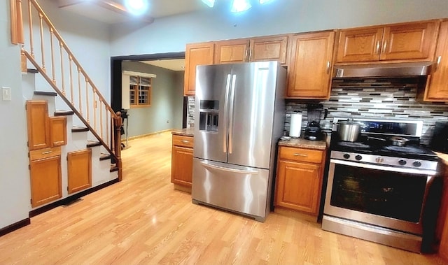 kitchen featuring backsplash, stainless steel appliances, and light hardwood / wood-style flooring