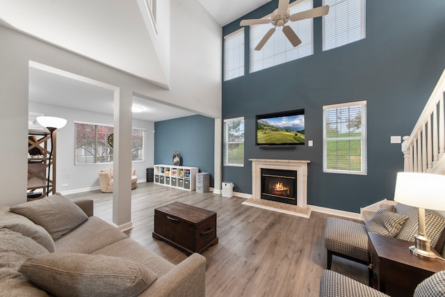 living room with high vaulted ceiling, hardwood / wood-style floors, and ceiling fan