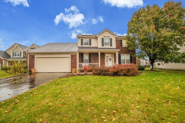 front of property featuring a garage, a front yard, and a porch