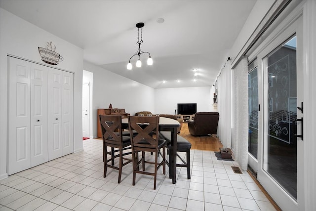 dining area featuring light wood-type flooring and a notable chandelier