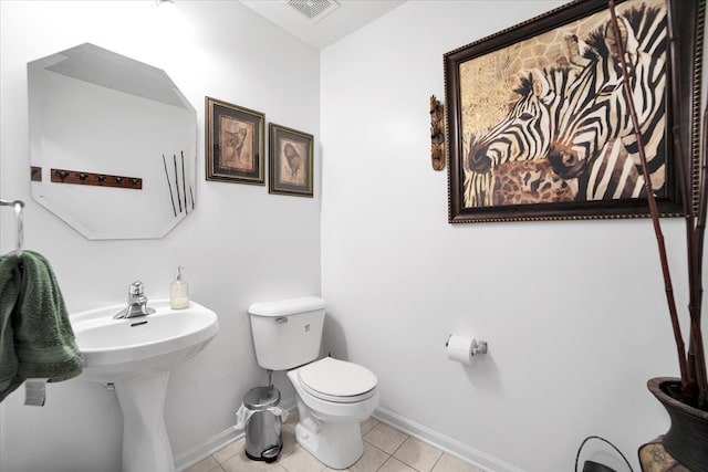 bathroom featuring tile patterned flooring and toilet