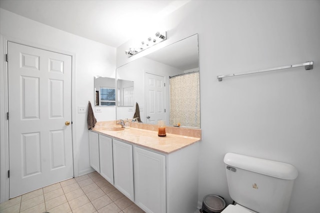 bathroom featuring vanity, tile patterned floors, and toilet