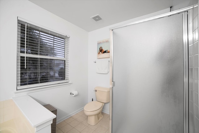 bathroom featuring tile patterned flooring, an enclosed shower, and toilet