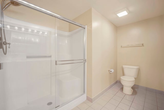 bathroom with tile patterned flooring, an enclosed shower, and toilet