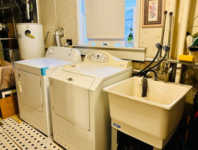 laundry room featuring water heater, sink, and washing machine and clothes dryer