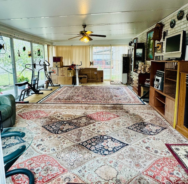 living room with brick wall and ceiling fan