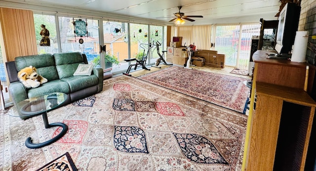 living room with ceiling fan and plenty of natural light