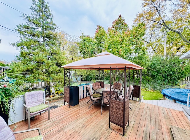 wooden deck with a covered pool and a gazebo