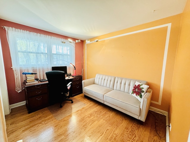 home office with light hardwood / wood-style floors