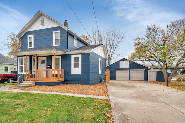 view of front facade featuring a garage, an outdoor structure, a front lawn, and a porch