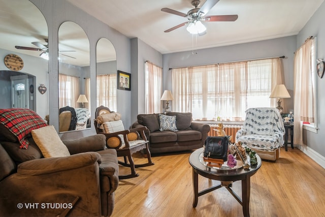 living room with light hardwood / wood-style flooring and ceiling fan