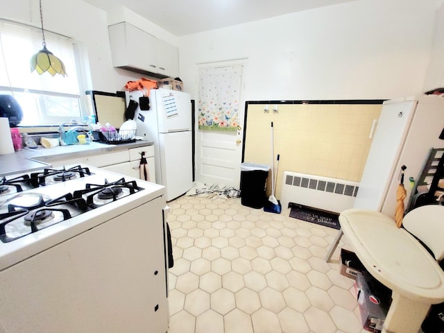 1100 N Harlem Ave Unit 1, River Forest, IL 60305 - kitchen featuring radiator heating unit, white appliances, white cabinets, light countertops, and decorative light fixtures