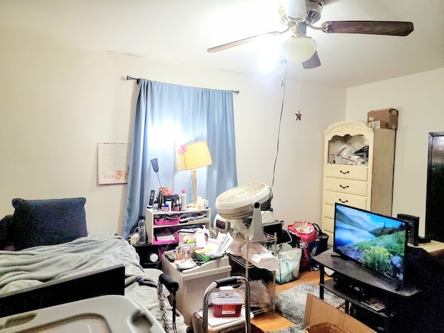 bedroom with hardwood / wood-style floors and ceiling fan