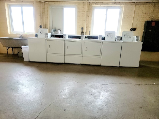 laundry area with washer and clothes dryer and sink