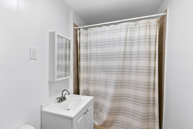 bathroom featuring vanity and a shower with shower curtain