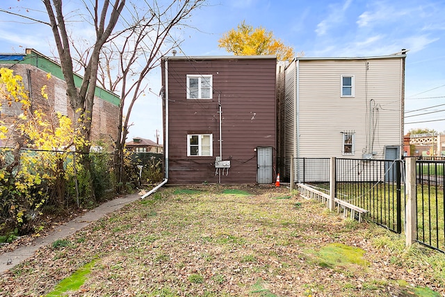 back of property featuring a lawn