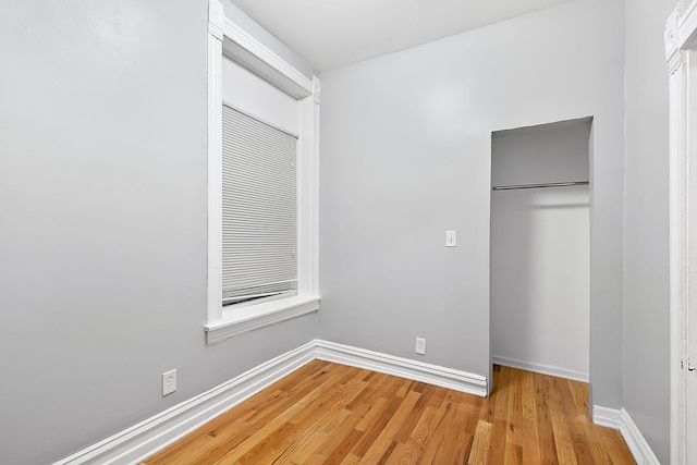 unfurnished bedroom with light hardwood / wood-style floors and a closet