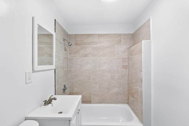 full bathroom featuring vanity, toilet, and tiled shower / bath