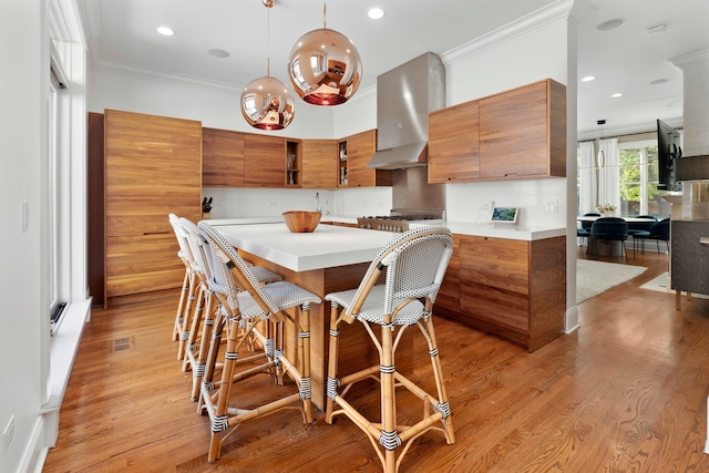 dining space with light hardwood / wood-style flooring and ornamental molding