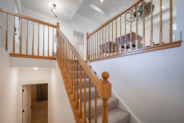 stairway featuring a high ceiling