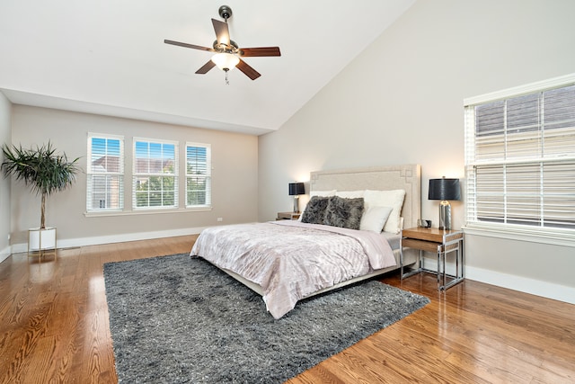 bedroom with high vaulted ceiling, wood-type flooring, and ceiling fan