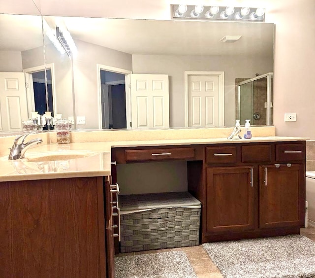 bathroom featuring vanity and a shower with door