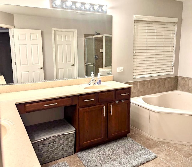 bathroom featuring shower with separate bathtub, vanity, and tile patterned flooring