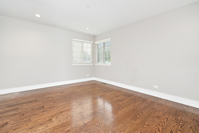 unfurnished room with hardwood / wood-style flooring