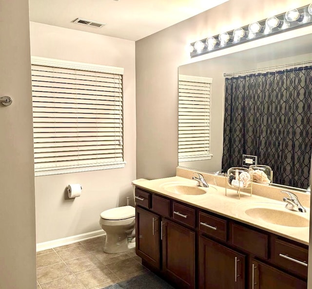 bathroom featuring toilet, a shower with curtain, vanity, and tile patterned floors