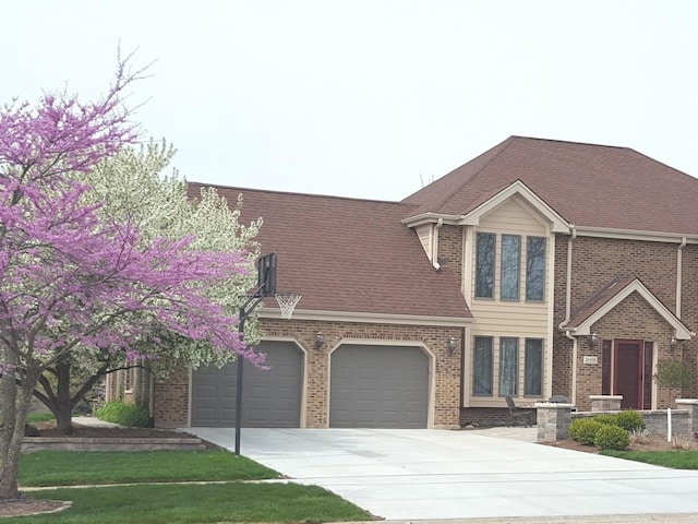 view of front of property with a garage, brick siding, concrete driveway, and a shingled roof