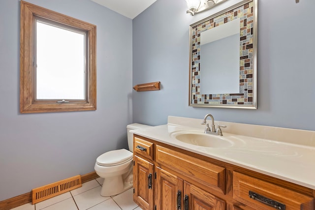 bathroom with tile patterned flooring, vanity, and toilet