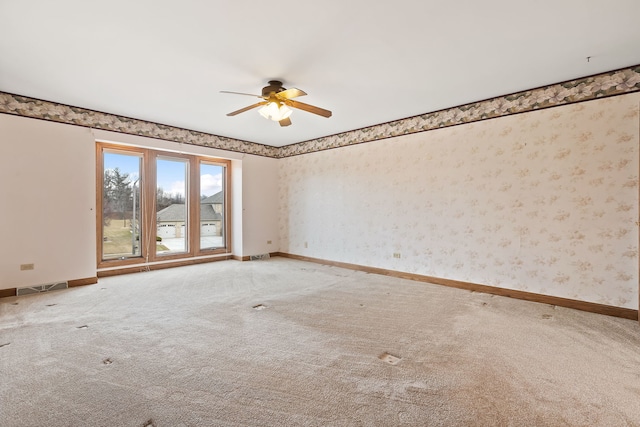 carpeted spare room featuring ceiling fan