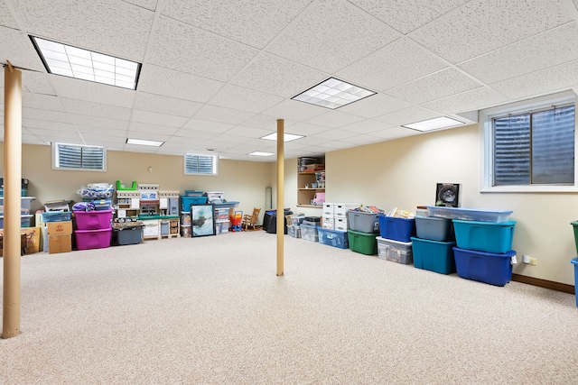 basement with carpet floors and a drop ceiling