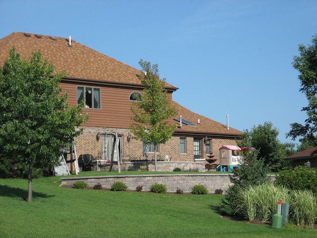 rear view of house with a yard