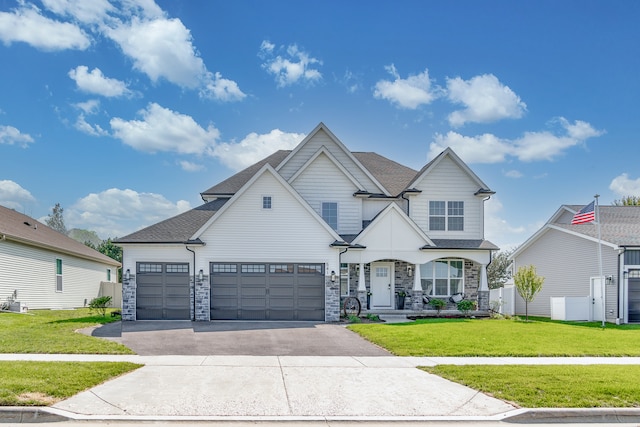 view of front of property with a garage and a front lawn