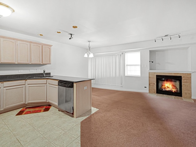 kitchen with light carpet, dishwasher, sink, and light brown cabinets