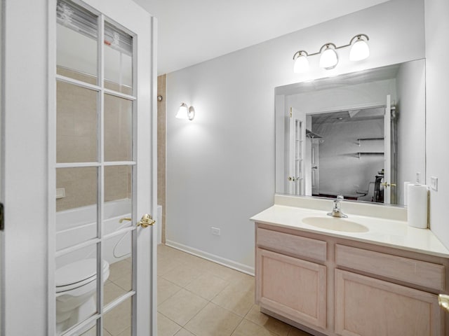 full bathroom featuring tile patterned floors, tiled shower / bath combo, toilet, and vanity