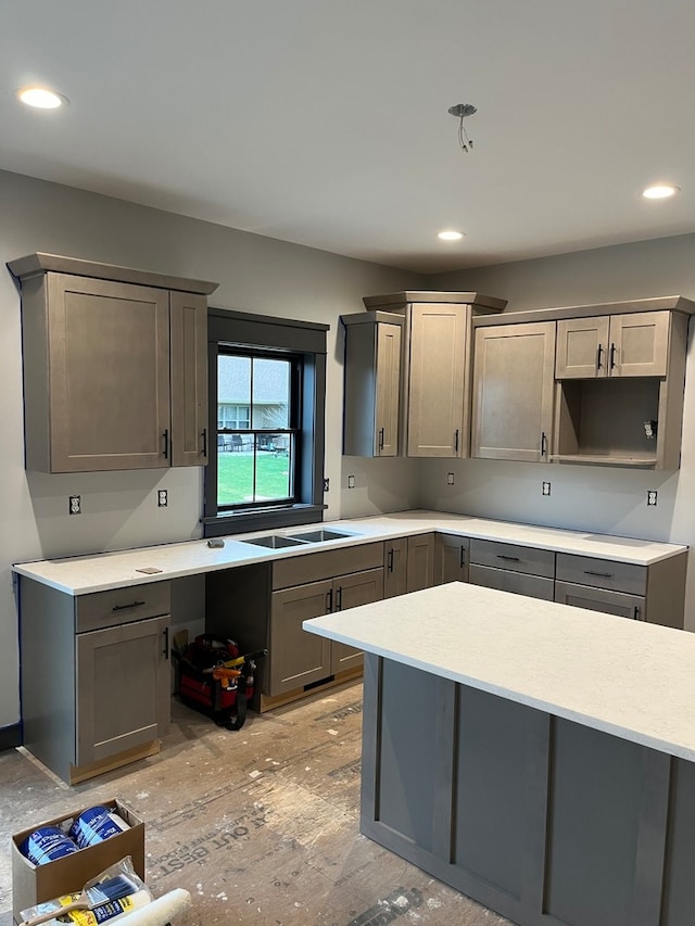 kitchen with light wood-type flooring and gray cabinetry