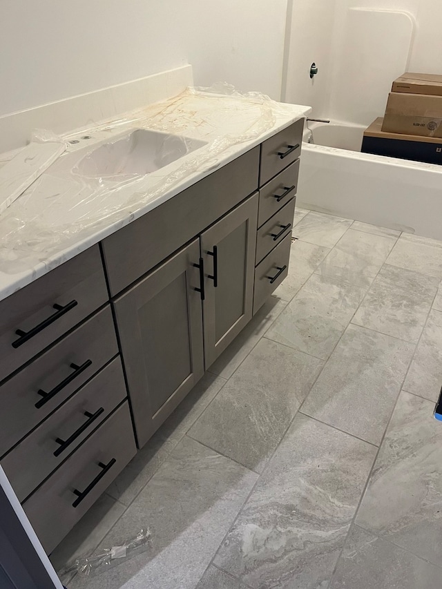 bathroom with a bathing tub and vanity