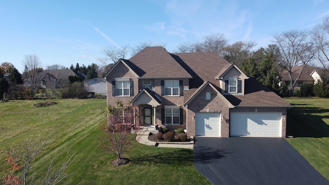 view of front of property featuring a front lawn and a garage