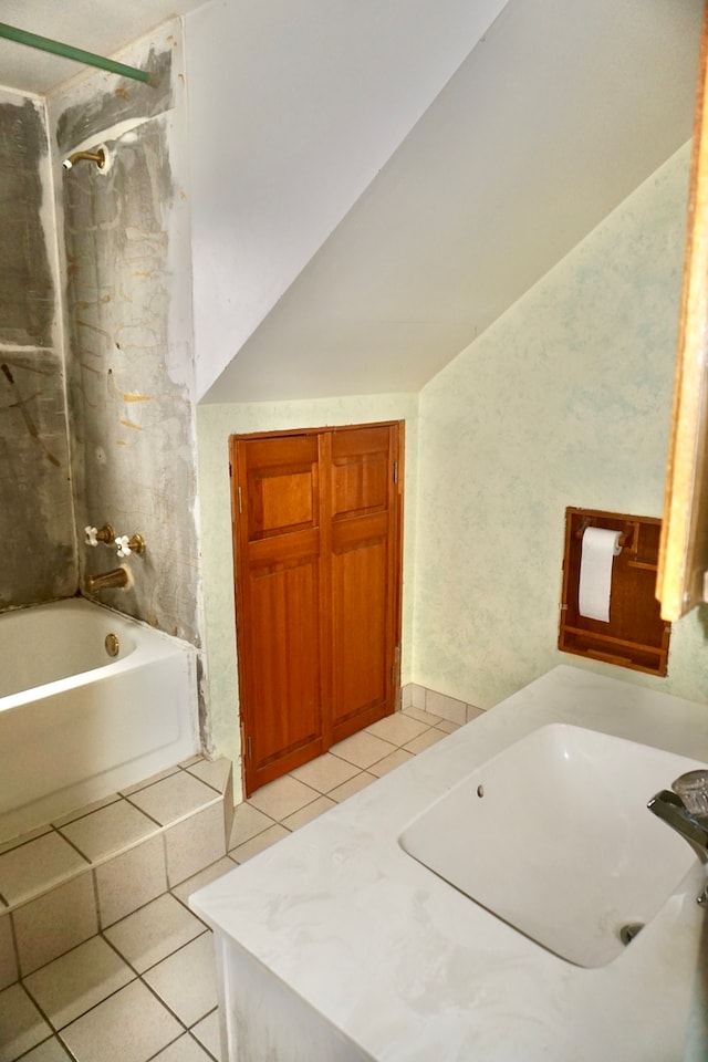 bathroom with tile patterned floors and tiled shower / bath