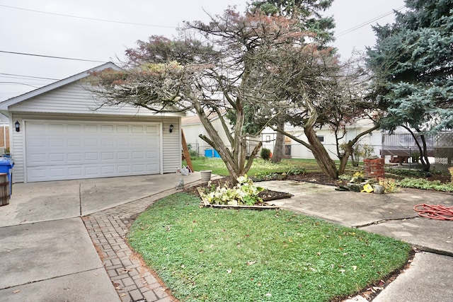 view of front of property featuring a garage and a front lawn