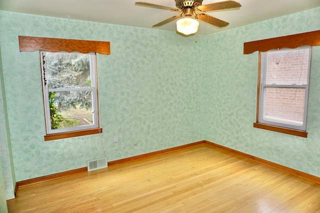 spare room with wood-type flooring and ceiling fan