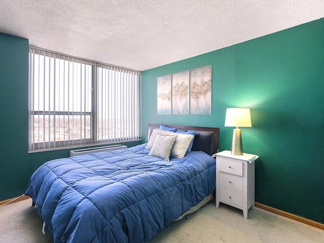 bedroom with carpet, a textured ceiling, and baseboards