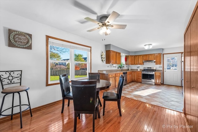 dining area featuring light hardwood / wood-style floors and ceiling fan