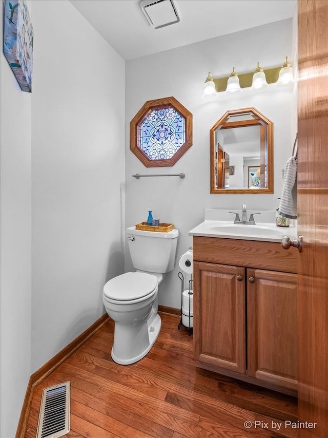 bathroom featuring hardwood / wood-style floors, vanity, and toilet