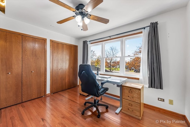 office area with light hardwood / wood-style floors and ceiling fan